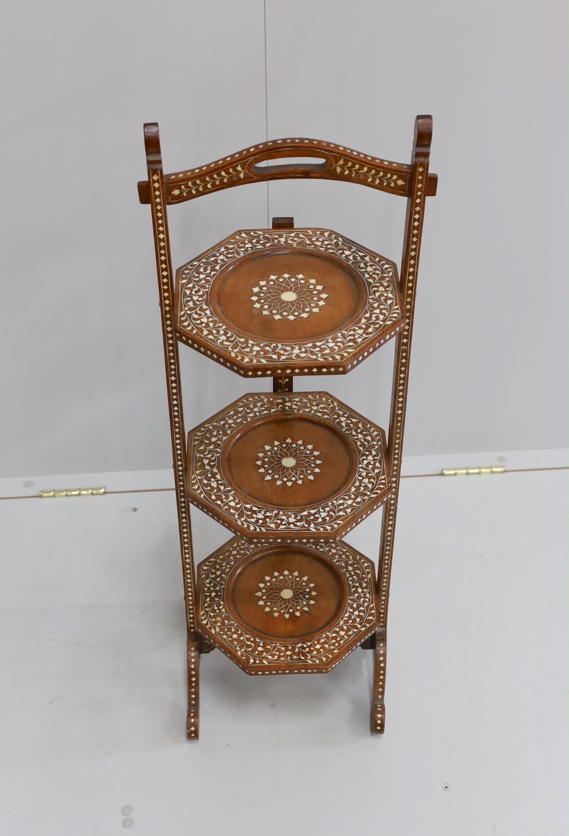 A George III style mahogany wash stand, together with an Indian bone inlaid three tier folding cake stand